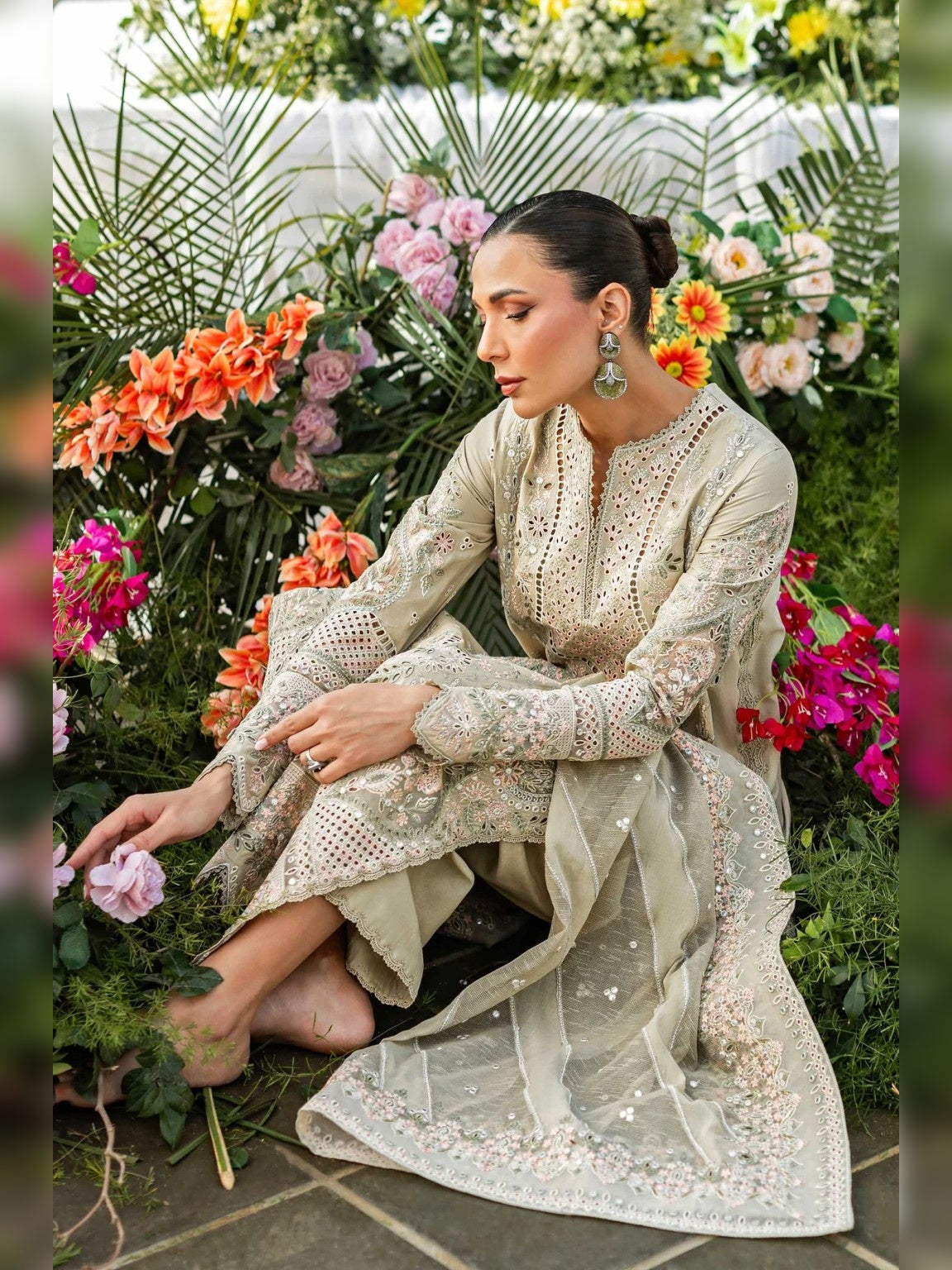 Akber Aslam Replica embroidered beige lawn suit sitting pose in garden